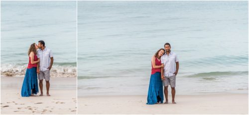 Waves rolling in as couple cuddles on beach Melbourne Beach Engagement Photography