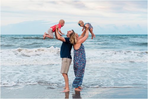Family holding up kids during Family Beach Portraits in Melbourne Beach, Florida