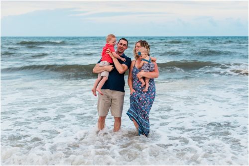 Family playing in ocean during Family Beach Portraits in Melbourne Beach, Florida