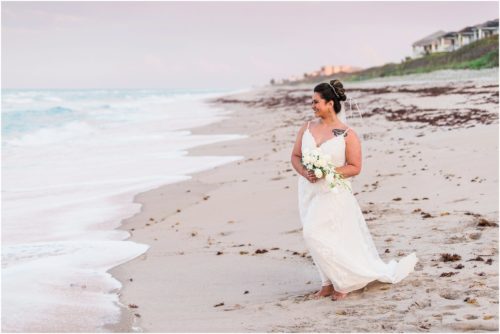 Bride alone on beach Melbourne Beach elopement