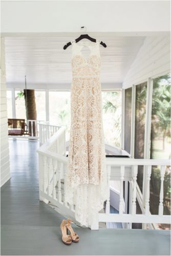 Dress hanging on porch of Decklan house Up The Creek Farms Wedding Photography