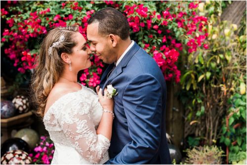 bride and groom with flowers Grand Manor Wedding