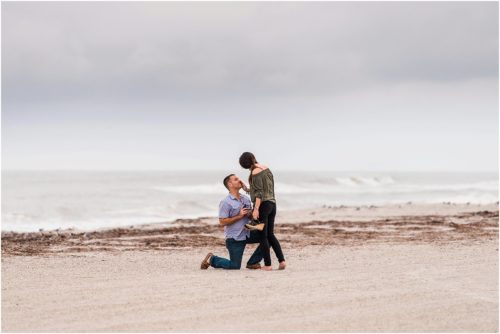 Man down on one knee proposing on beach Melbourne Proposal Photographer
