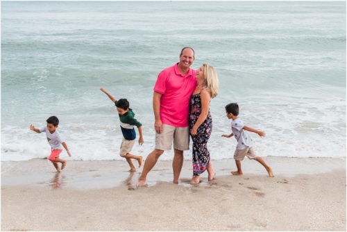 Grandkids hugging their grandparents near the water with Melbourne Beach Photographer Liz Cowie