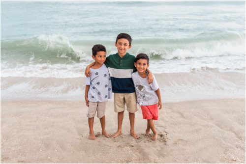Three boys laughing by the edge of the water with Melbourne Beach Photographer Liz Cowie