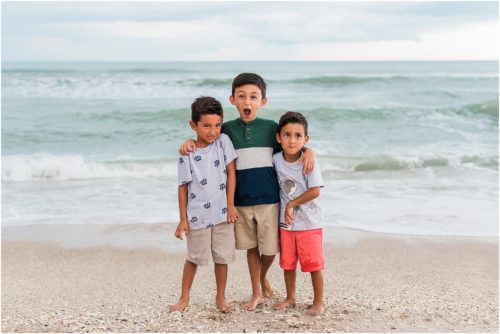 Three boys laughing by the edge of the water with Melbourne Beach Photographer Liz Cowie