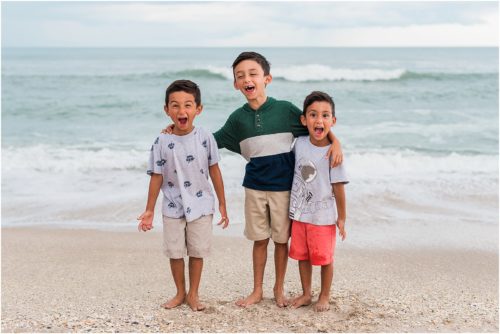 Three boys laughing by the edge of the water with Melbourne Beach Photographer Liz Cowie