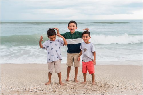 Three boys laughing by the edge of the water with Melbourne Beach Photographer Liz Cowie