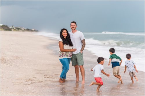 Kids running around parents with Melbourne Beach Photographer Liz Cowie