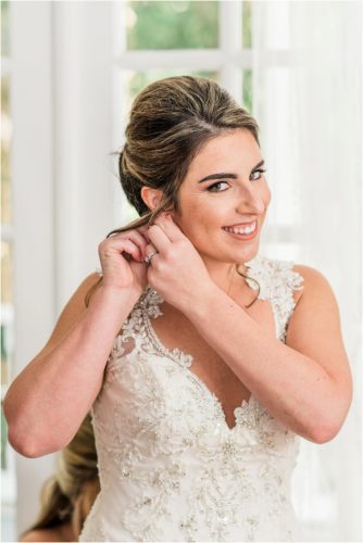 Bride putting ear ring in at Up the Creek Farms Melbourne Wedding Photographer