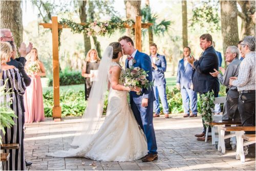 Bride and groom kissing in middle of asile at Up the Creek Farms Melbourne Wedding Photographer