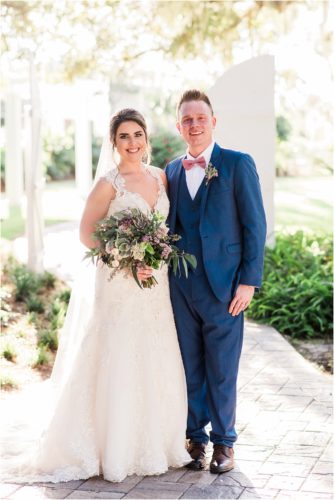Bride and groom by white barn doors at Up the Creek Farms Melbourne Wedding Photographer