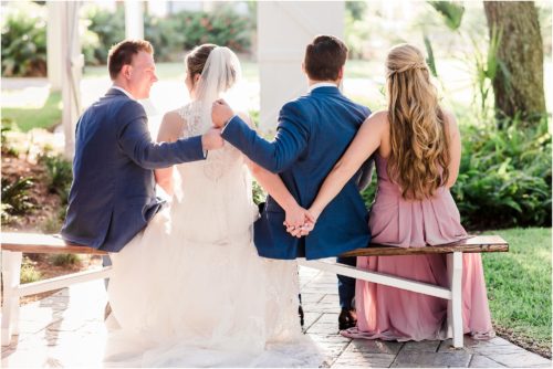 Groom and best man fist pump and bride and maid of honor holding hands at Up the Creek Farms Melbourne Wedding Photographer