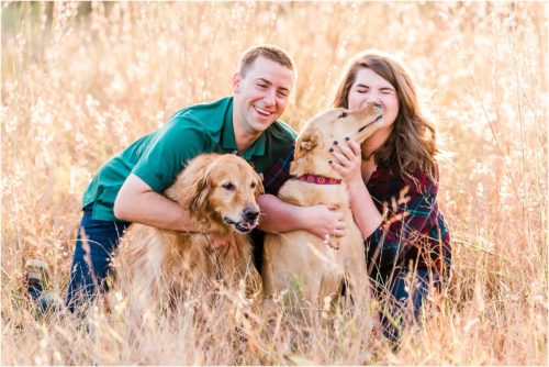 Couple snuggling with dogs in field Melbourne Florida Family Photography