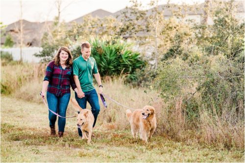 A couple walking dogs near a field Melbourne Florida Family Photography