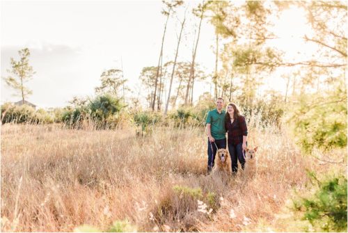 Couple laughing in field with 2 dogs Melbourne Florida Family Photography