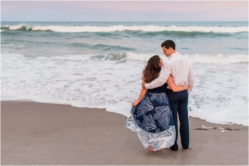 couple hugging by edge of water engagement photography