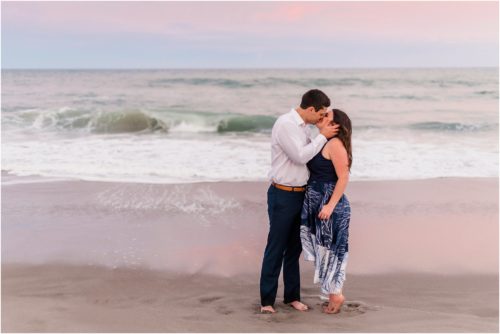 couple kissing on beach at sunset