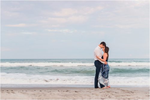 Couple with ocean in background engagement photography