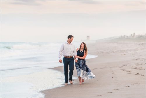 Couple walking on beach engagement photography