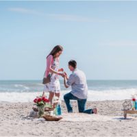 Down on a knee in front of the ocean during a Florida Beach Proposal