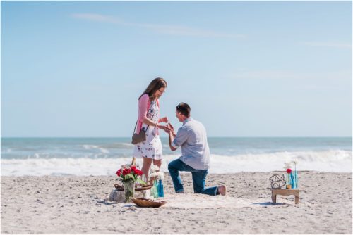 Down on a knee in front of the ocean during a Florida Beach Proposal
