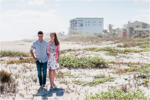 couple walking on dunes during a Florida Beach Proposal