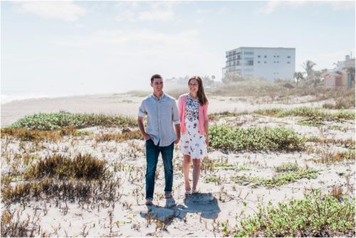 couple walking on dunes during a Florida Beach Proposal