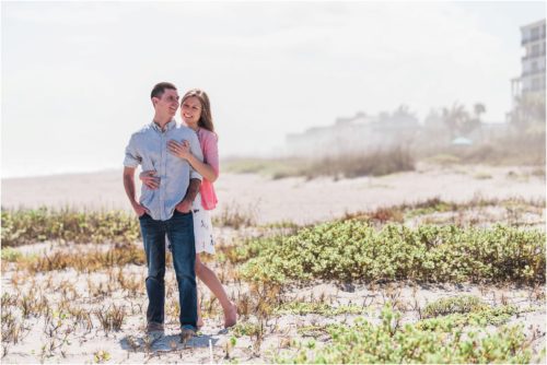 couple hugging by dunes during a Florida Beach Proposal