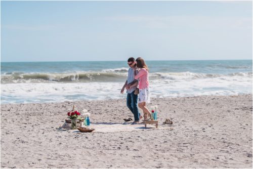 walking towards blanket on the beach during a Florida Beach Proposal