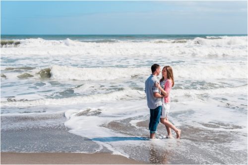 hugging while waves crash on ocean during a Florida Beach Proposal