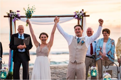 Bride and groom cheering during Cocoa Beach Sunrise Wedding