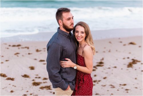 couple snuggling during Floridana Beach engagement
