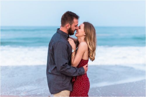 couple giggling on beach during Floridana Beach engagement