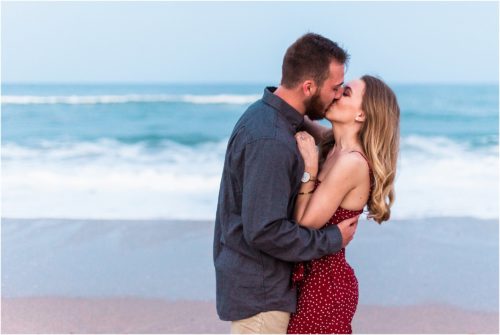 couple kissing with waves crashing during Floridana Beach engagement