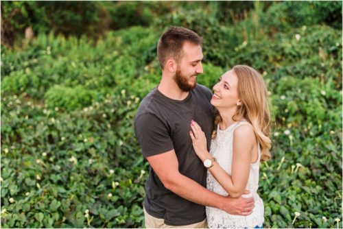 Couple hugging during Floridana Beach engagement
