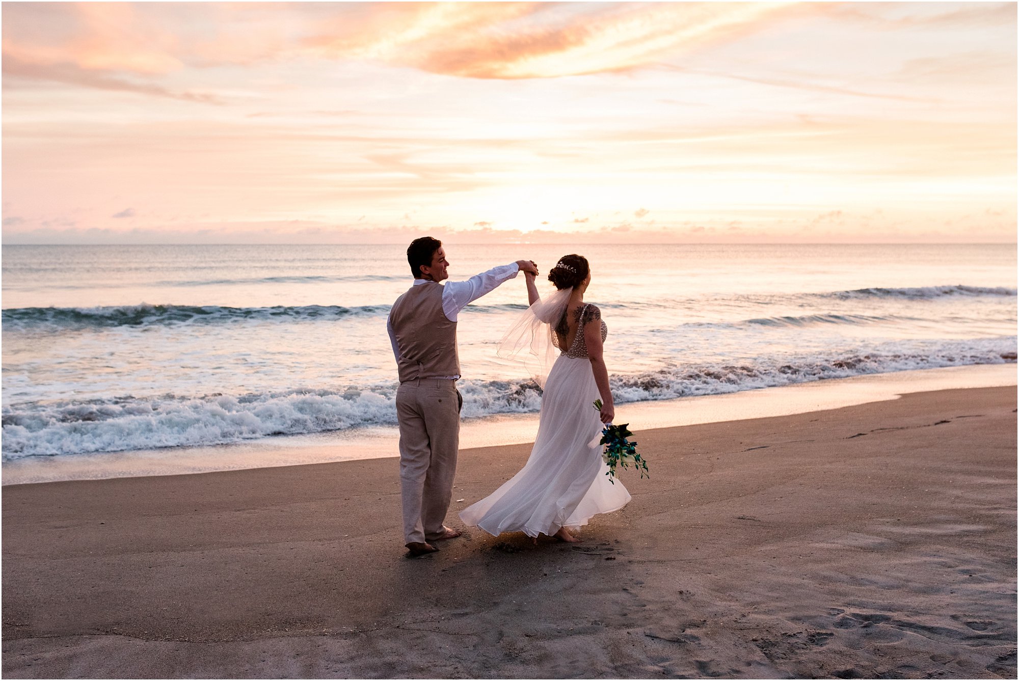Groom twirling bride during Cocoa Beach Sunrise Wedding