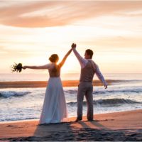 Bride and groom looking at the sunrise during Cocoa Beach Sunrise Wedding