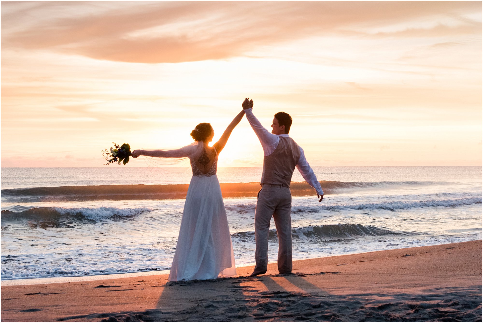 Bride and groom looking at the sunrise during Cocoa Beach Sunrise Wedding