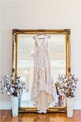 Gown hanging on mirror at Banyan Estate Wedding