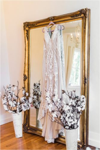Gown hanging on mirror at Banyan Estate Wedding