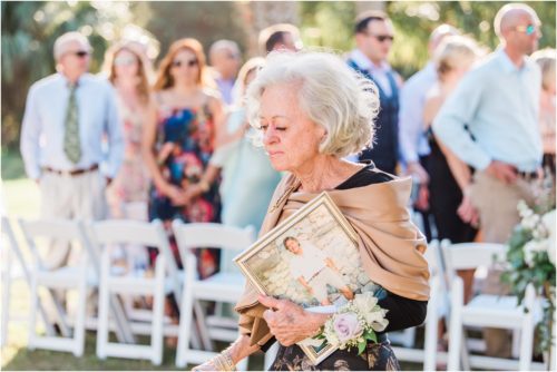 Mother of bride carrying a picture of the father of the bride at Banyan Estate Wedding