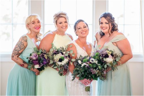 Girls by big windows with purple bouquets at Banyan Estate Wedding
