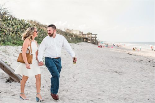 Couple walking onto the beach during Satellite beach proposal