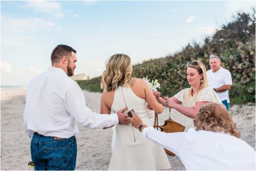 Mom giving son the ring behind the girls back during Satellite beach proposal