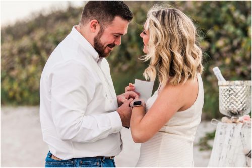 Man putting ring on girls finger during Satellite beach proposal