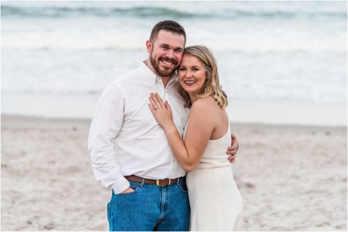 Newly engaged couple on beach during Surprise Proposal