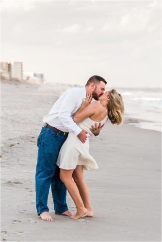A kiss on the beach during Surprise Proposal