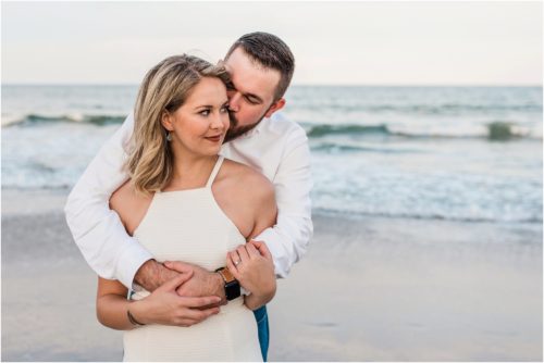 Hugging on beach during Surprise Proposal