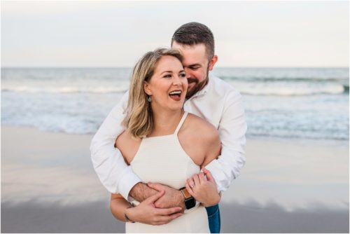Laughing on beach during Surprise Proposal